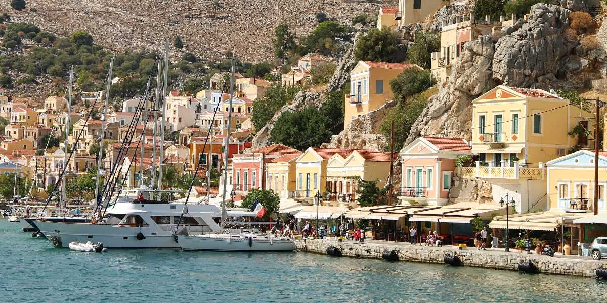 port in Symi, ships, traditional buildings, mountain