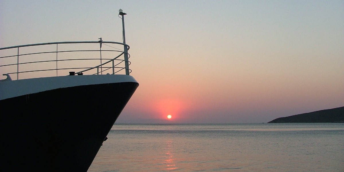 pink and purple sky from the sunset, ferry bow near Tilos