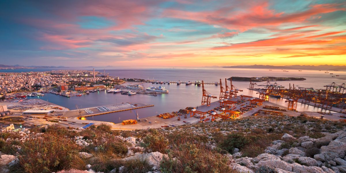 Sunset hour at the port of Piraeus, lighthouse, ferries, dock