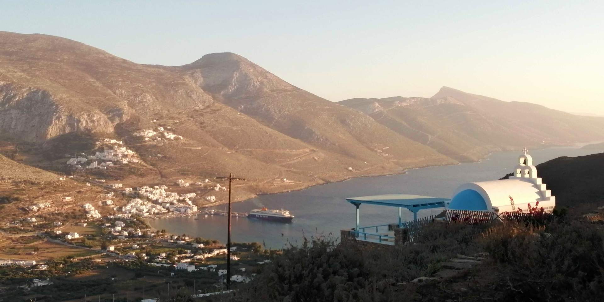 Ferry departing from the port of Aigiali in Amorgos, view of the port from Tholaria village