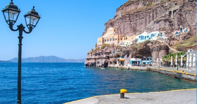 The picturesque old port with blue and orange houses in Oia, Santorini 