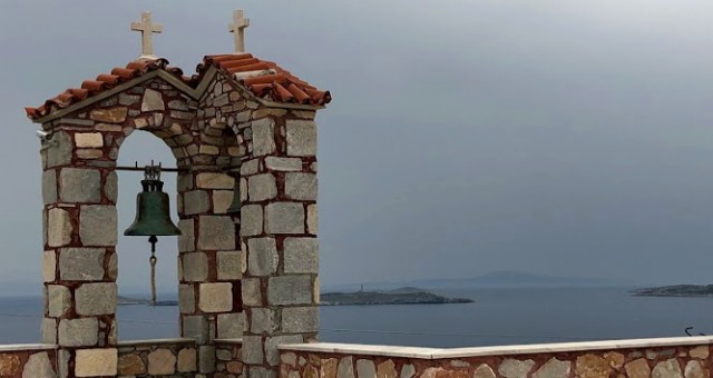 Stone church with red tiles in Syros, Greece