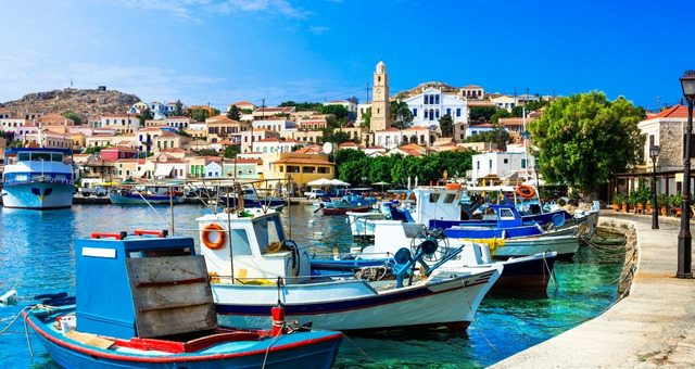 Colorful houses surrounding the port of Halki