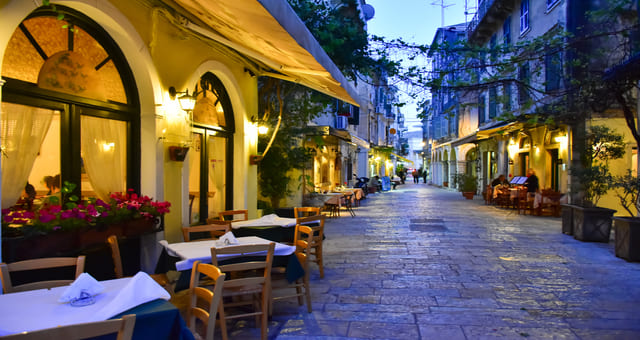 Restaurant terraces at night in Corfu in Greece