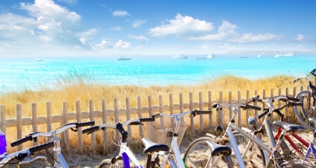 Bikes lined up next to a beach in Formentera, Balearic Islands, Spain