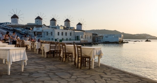 Windmills over a seaside restaurant in Mykonos