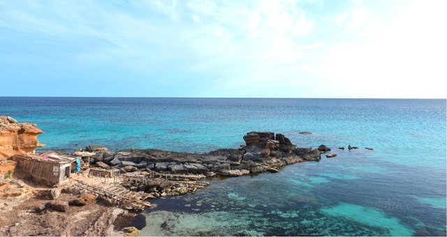 Wooden fisher cabin at the rocky coast of Es Caló