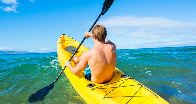 Person holding row on a yellow kayak