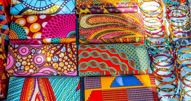 Colorful handbags and bracelets selling at a market stand