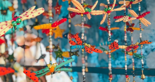 Colorful beaded wind chimes hanging at a market stall 