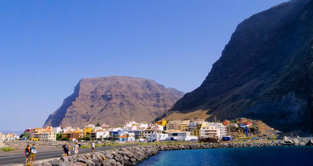 People walking across the promenade of Valle Gran Rey in La Gomera, Spain