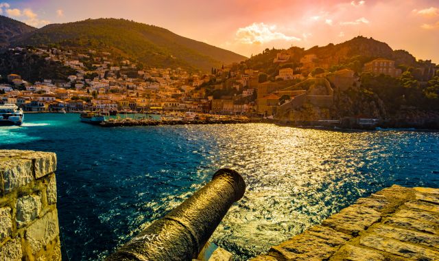 Sunset view of old cannons in Hydra, Greece