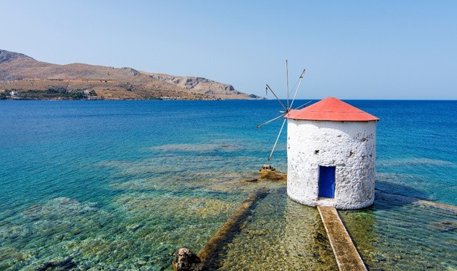 Old windmill in the sea in Leros, Greece