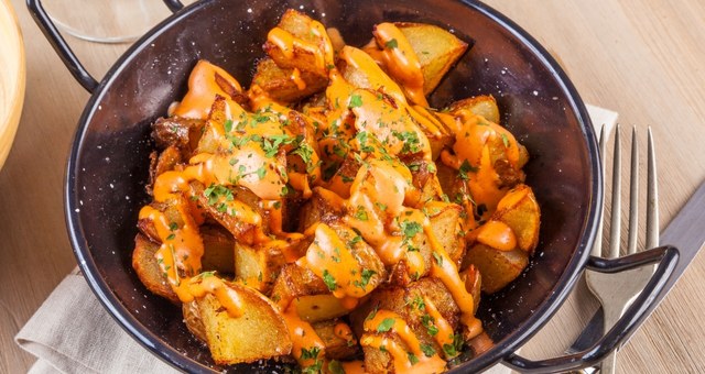 Pot with spicy "patatas bravas", a Spanish dish