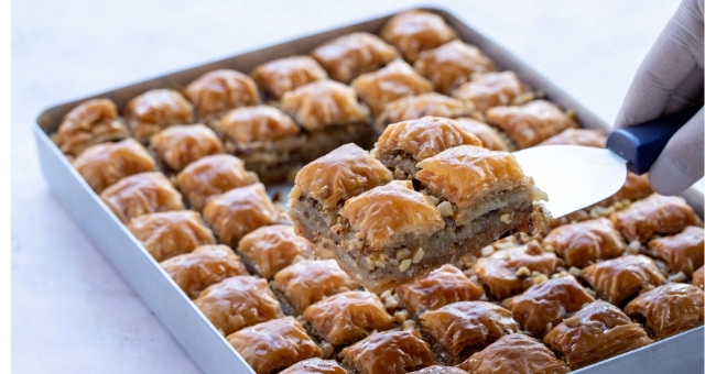 A tray filled with walnut baklava pastries 