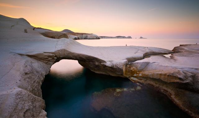 Rocky volcanic beach in Milos at sunset