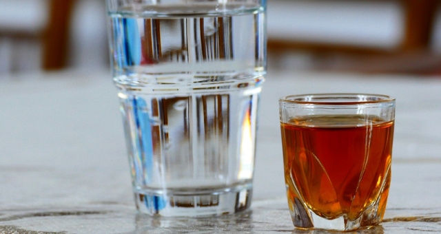 A glass of Amorgos’ “rakomelo” and a glass of water