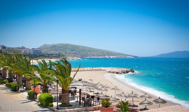 Umbrellas and sunbeds at the beach of Sarandë in Albania