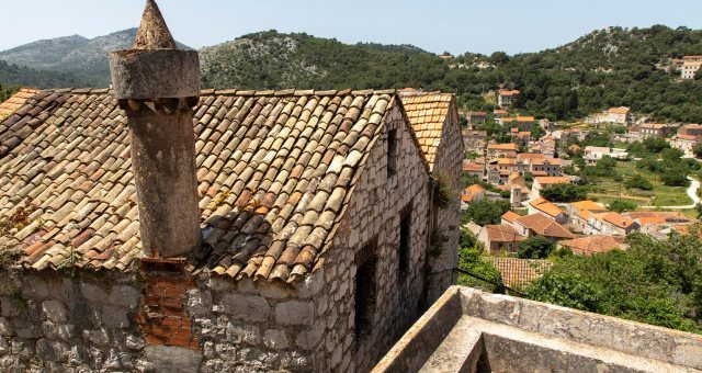 A traditional stone house adorned with a characteristic chimney, fumari in Lastovo, Croatia