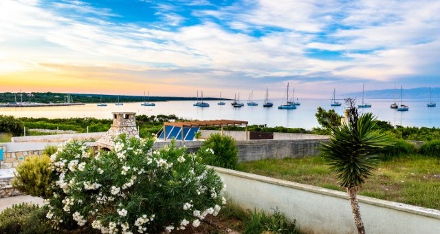 Sunset panorama with sailing boats over Sotorišće bay on Silba island, Croatia