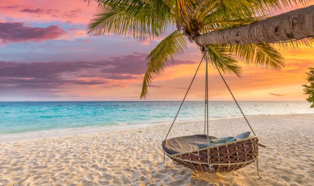 Sunset view of swing on a beach in Bali, Indonesia
