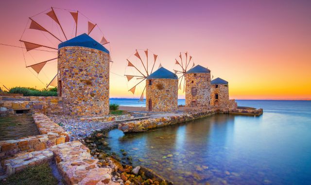 Sunset view of ancient mills near the port of Chios, Greece