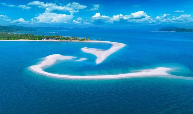White sand dunes emerging from blue waters at a beach in Koh Yao Yai, Thailand