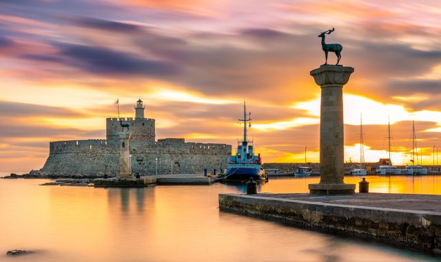 Sunset in Mandraki harbor, Rhodes, Dodecanese, Greece