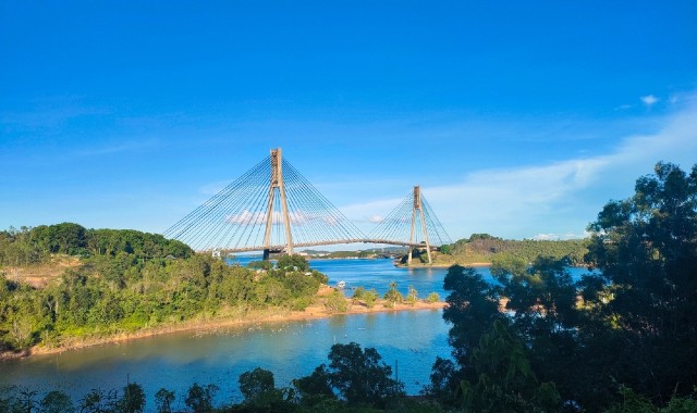 View of the Barelang Bridge surrounded by greenery and blue waters in Batam, Indonesia