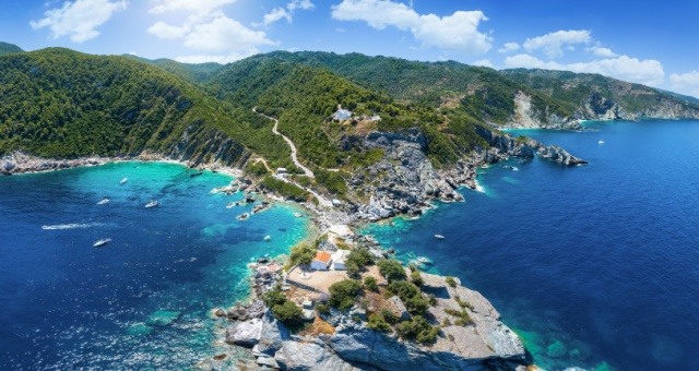The coast of Skopelos island, Greece, with the church of Agios Ioannis on a rock over the Aegean Sea
