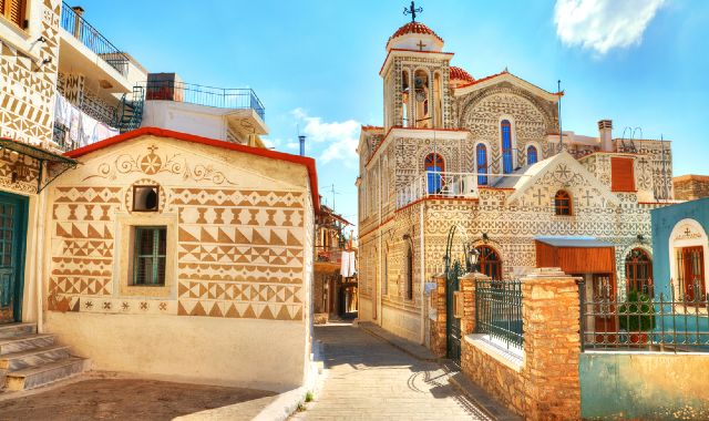 Houses and church in Pyrgi village on the island of Chios decorated with geometric motifs and standing between narrow streets