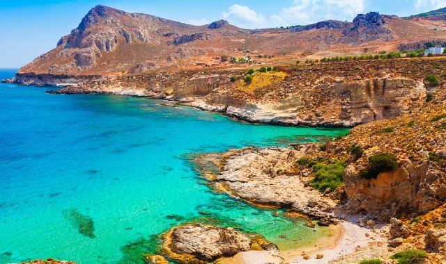 Panoramic view of the rugged coastline near Stegna Beach and Archangelos in Rhodes, with clear blue waters and rocky cliffs 