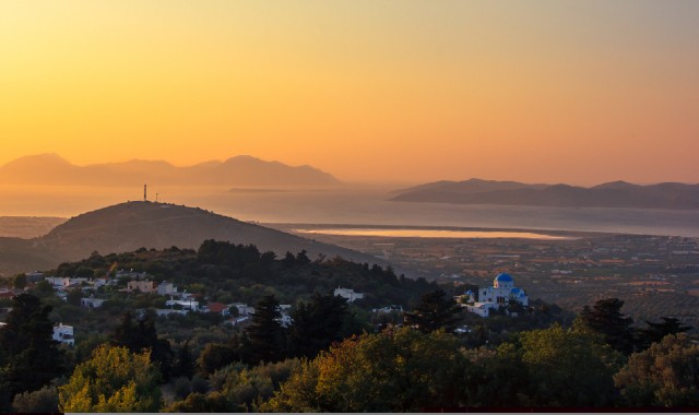 Colourful sunset over the village of Zia and the island of Kos, in Greece