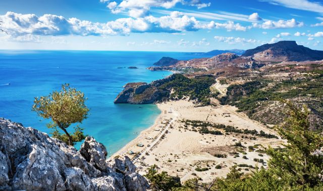 View of Tsambika Beach in Rhodes from nearby monastery in the rugged hills