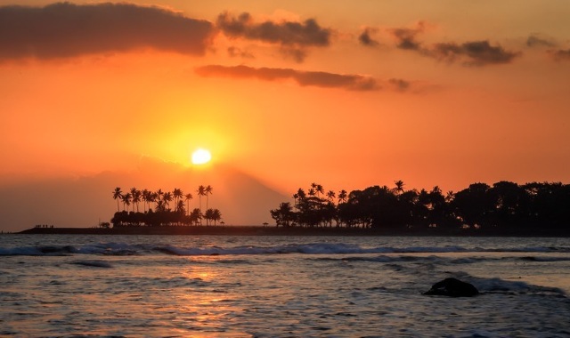 Orange skies as sun sets over a Senggigi beach, in Indonesia