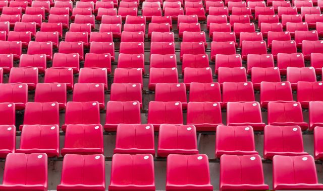 Rows of red seats in football stadium