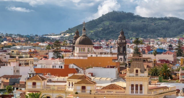 Aerial view of La Orotava town with terracotta rooftops and surrounding green hills in Tenerife