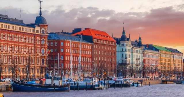Sunset view of Helsinki’s skyline with boats on the water, Finland