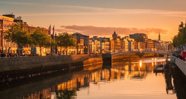 Orange skies as the sun sets over the city of Dublin and the River Liffey