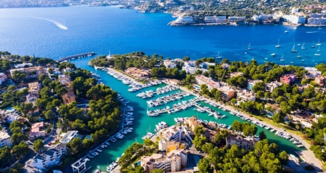 Yachts moored in the green-fringed marina of Santa Ponsa in Mallorca, Spain