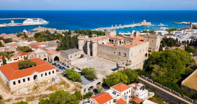 The medieval Palace of the Grand Master in Rhodes Old Town with the port and sea in the background, Greece