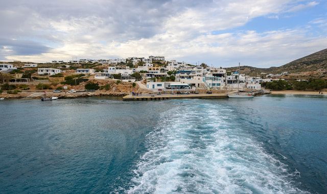 View from a departing ferry looking back at the coastal village and small port of Donousa in Greece