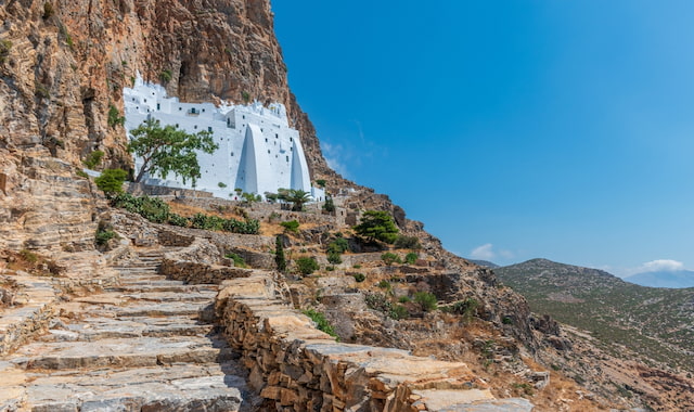 The white cliffside Monastery of Panagia Hozoviotissa built into a steep rock face in Amorgos, Greece