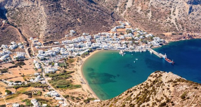 The port town of Kamares nestled in a bay in Sifnos, Greece