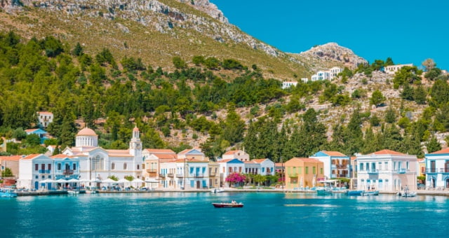 Colorful neoclassical houses along the turquoise waterfront of Kastellorizo, Greece