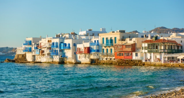 Traditional white houses with blue balconies in Mykonos Chora, Greece
