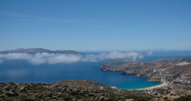 Elevated panoramic view of a Mylopotas beach under low clouds in Ios, Greece