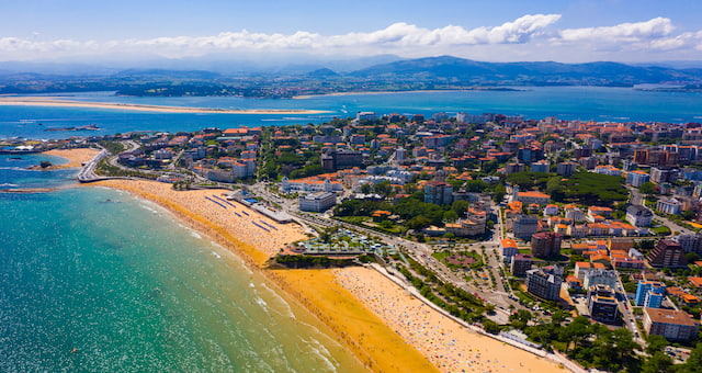 The golden sandy beach and cityscape of Santander, in Spain