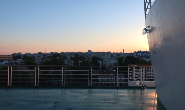 sunset on deck, ferry handrail, Kimolos