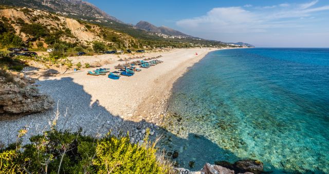 Sunbeds and umbrellas on the Dhermi beach in Vlorë, Albania